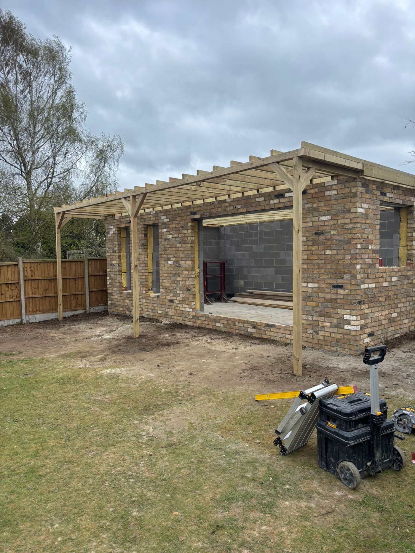 Brick garden room with timber pergola