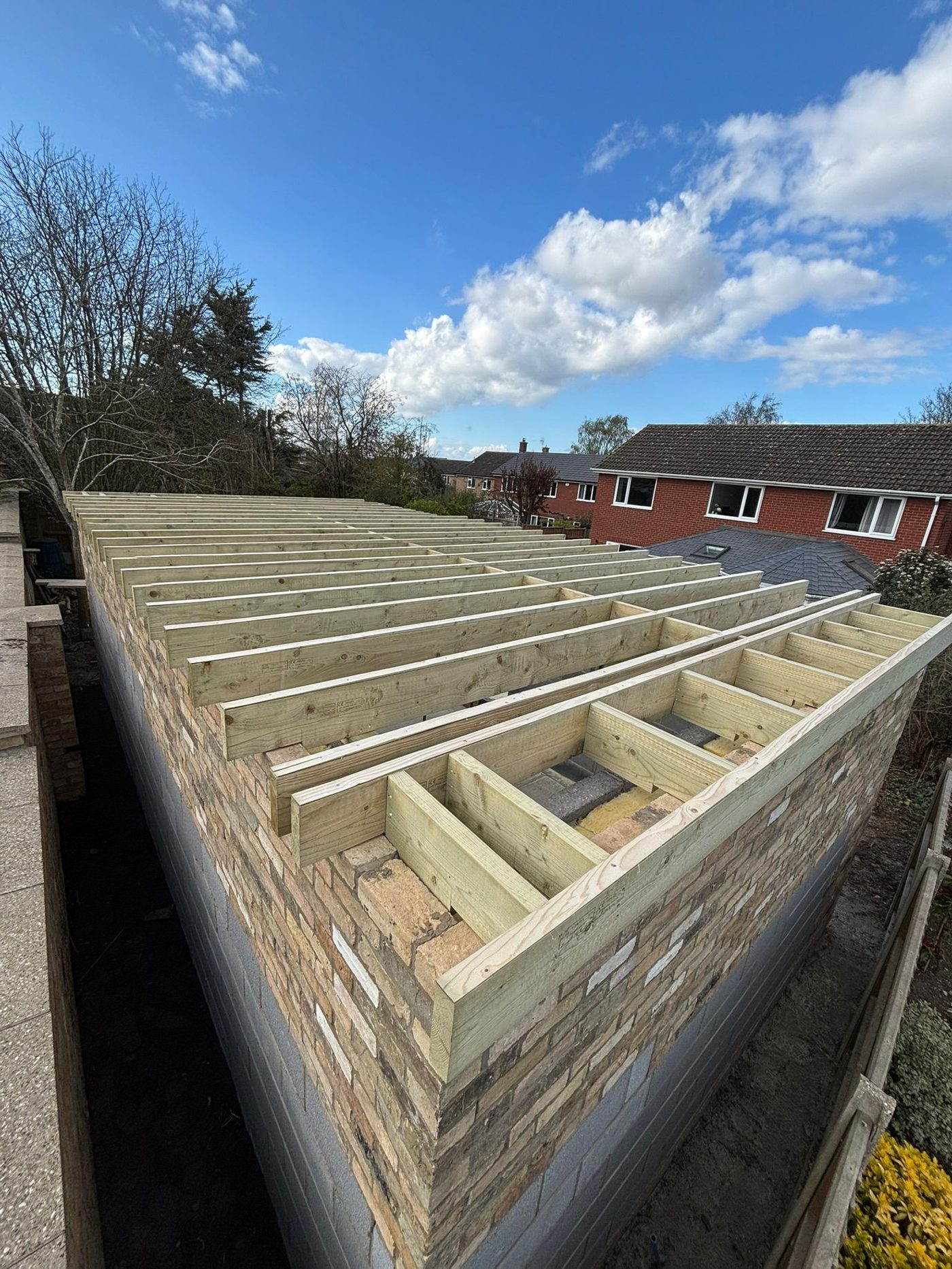 Timber roof joists installed on brick walls
