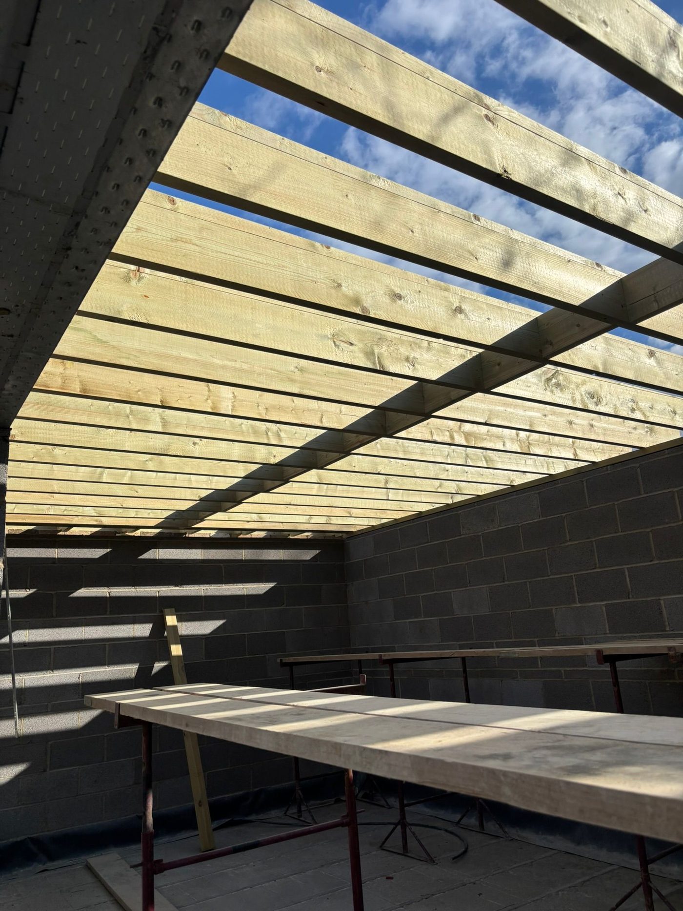 Looking up at timber roof beams from below
